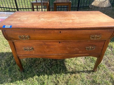 Sale Photo Thumbnail #74: A vintage wooden chest featuring two long drawers with ornate metal brass-tone bail handles, keyhole accents, and French/cabriole style front legs. The surface shows age-appropriate wear, surface scratches, water rings, and finish loss throughout, consist