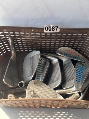 Sale Photo Thumbnail #110: A collection of vintage golf iron club heads including Simmons Tiger Shark USA models (3-iron, 8-iron, 9-iron, and others). Metal construction with signature blue cavity slot fill and etched shark logo details. Heads show play wear and surface patina typi