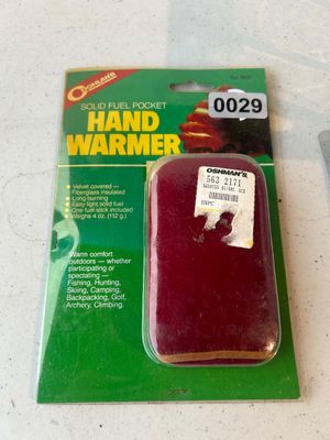 Sale Photo Thumbnail #29: A vintage Coghlan's Solid Fuel Pocket Hand Warmer (No. 8530), new and sealed in its original blister pack. Features a red velvet-covered, fiberglass-insulated case designed to use solid fuel sticks for outdoor activities such as hunting, fishing, and camp