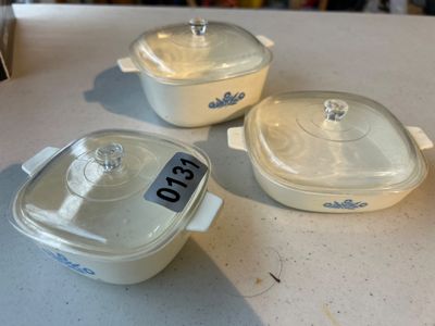 Sale Photo Thumbnail #195: Set of 3 vintage Corning Ware square casserole dishes featuring the iconic blue Cornflower pattern. Includes clear glass lids for each dish. Items appear to be in good vintage condition with minor surface wear typical of age and use.