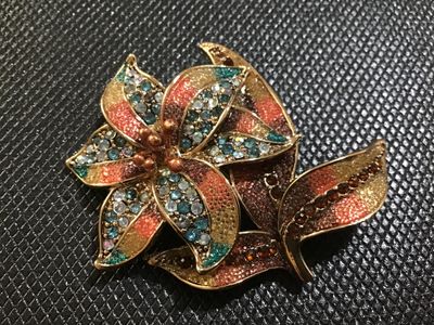 Sale Photo Thumbnail #63: A floral statement brooch by Liz Claiborne (marked 'LC' on reverse). Designed with gold-tone metal, colorful textured enamel/glitter accents in shades of orange, yellow, and brown, and studded with blue, aurora borealis, and amber rhinestones. Features a 