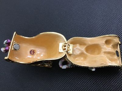 Sale Photo Thumbnail #11: Decorative enameled metal hinged trinket box shaped like a Christmas sleigh filled with toys, a teddy bear, presents, candy canes, and a Christmas tree. Features rhinestone accents along the rim, gold-tone metal runners, magnetic closure, and a painted en