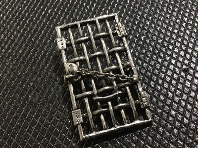 Sale Photo Thumbnail #41: A unique vintage pewter brooch pin designed as a jail door/gate with bars, hinges, and a padlock with chain detail across the front. The back is marked with "NWP" and copyrighted "© 1977". Features a standard rollover safety clasp pin back. Good vintage 