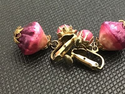 Sale Photo Thumbnail #8: A pair of vintage Vendome clip-on earrings featuring pink/fuchsia foil-wrapped teardrop dangle beads and pink pearlized tops set in gold-tone metal. Marked 'Vendome' on the clip mechanism with screw-back tension adjustments. In good vintage condition with