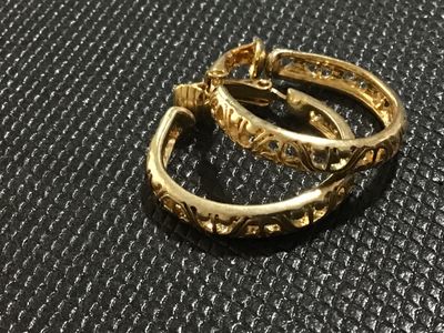 Sale Photo Thumbnail #54: Pair of vintage gold-tone hoop clip-on earrings featuring intricate openwork filigree detailing. Hinged clip-back mechanism designed for non-pierced ears. Good pre-owned condition with light surface wear consistent with age.
