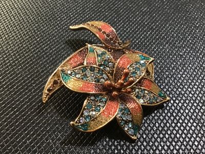Sale Photo Thumbnail #64: A floral statement brooch by Liz Claiborne (marked 'LC' on reverse). Designed with gold-tone metal, colorful textured enamel/glitter accents in shades of orange, yellow, and brown, and studded with blue, aurora borealis, and amber rhinestones. Features a 