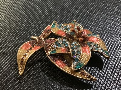 Sale Photo Thumbnail #65: A floral statement brooch by Liz Claiborne (marked 'LC' on reverse). Designed with gold-tone metal, colorful textured enamel/glitter accents in shades of orange, yellow, and brown, and studded with blue, aurora borealis, and amber rhinestones. Features a 