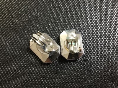 Sale Photo Thumbnail #57: Pair of vintage clip-on costume earrings featuring large emerald-cut purple faceted faux /rhinestone focal stones mounted on silver-tone metal clip backs. Good vintage condition with light wear on the metal backs.