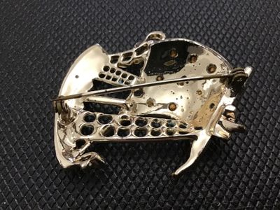 Sale Photo Thumbnail #26: Vintage nautical sailing ship brooch pin featuring white, light blue, and black enamel accents with clear rhinestone details set in gold-tone metal. Standard pin stem and safety clasp on the reverse. Shows minor wear to the enamel and finish consistent wi