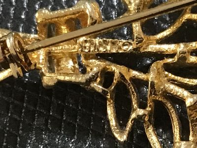 Sale Photo Thumbnail #83: Vintage gold-tone brooch featuring an intricate openwork leaf spray or bouquet motif with textured and beaded detailing. Marked 'Lisner on the reverse side. Secured with a standard pin stem and rollover safety clasp. Shows light vintage wear appropriate f