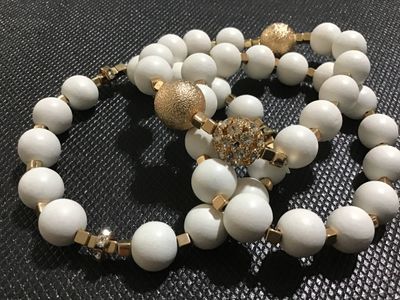 Sale Photo Thumbnail #115: Set of three elastic stretch bracelets featuring smooth matte white beads, gold-tone square spacers, textured gold-tone accent beads, and sparkling crystal rhinestone details. Appears to be in good, pre-owned condition with no missing stones visible.