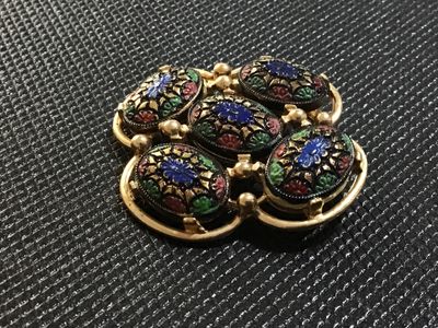 Sale Photo Thumbnail #52: Vintage gold-tone brooch featuring five oval cabochons with colorful floral-style enamel details in blue, green, and red. The back is stamped '(C)SARAH COV' and has a working pin back closure. Shows minor age-appropriate surface wear on the back.