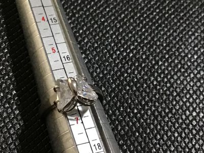 Sale Photo Thumbnail #72: 18 KtGPSilver-tone ring featuring a butterfly motif set with clear faceted stones forming the wings. Measures approximately size 6.5 on a ring mandrel. Shows minor surface wear consistent with light use.