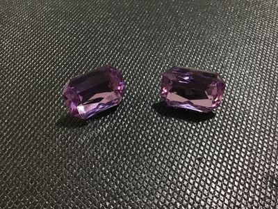 Sale Photo Thumbnail #56: Pair of vintage clip-on costume earrings featuring large emerald-cut purple faceted faux /rhinestone focal stones mounted on silver-tone metal clip backs. Good vintage condition with light wear on the metal backs.