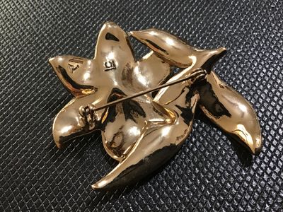 Sale Photo Thumbnail #66: A floral statement brooch by Liz Claiborne (marked 'LC' on reverse). Designed with gold-tone metal, colorful textured enamel/glitter accents in shades of orange, yellow, and brown, and studded with blue, aurora borealis, and amber rhinestones. Features a 
