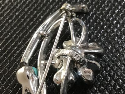 Sale Photo Thumbnail #50: A vintage Corosilver-tone floral spray brooch featuring openwork scroll design accents and three turquoise-colored cabochon beads. Signed 'Sara Coventry ' on the back. Has a safety pin catch closure. In good vintage condition with minor surface wear consi