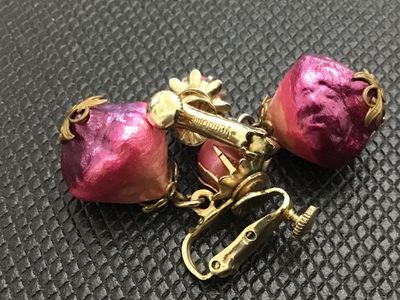 Sale Photo Thumbnail #6: A pair of vintage Vendome clip-on earrings featuring pink/fuchsia foil-wrapped teardrop dangle beads and pink pearlized tops set in gold-tone metal. Marked 'Vendome' on the clip mechanism with screw-back tension adjustments. In good vintage condition with