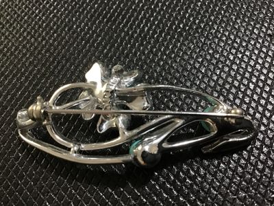 Sale Photo Thumbnail #49: A vintage Corosilver-tone floral spray brooch featuring openwork scroll design accents and three turquoise-colored cabochon beads. Signed 'Sara Coventry ' on the back. Has a safety pin catch closure. In good vintage condition with minor surface wear consi