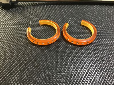 Sale Photo Thumbnail #97: Pair of translucent orange acrylic or resin hoop pierced earrings featuring a yellow inner lining and clear rhinestones set around the outer edge. Pierced post backs. Good pre-owned condition with minor signs of wear.