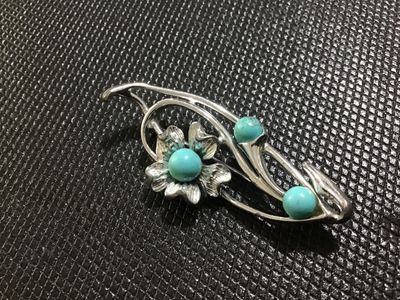 Sale Photo Thumbnail #48: A vintage Corosilver-tone floral spray brooch featuring openwork scroll design accents and three turquoise-colored cabochon beads. Signed 'Sara Coventry ' on the back. Has a safety pin catch closure. In good vintage condition with minor surface wear consi