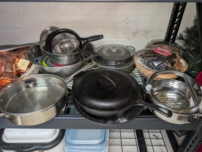 Sale Photo Thumbnail #15: Assorted kitchenware including a Lodge cast iron Dutch oven with lid, stainless steel cookware, metal strainers & copper molds. 
