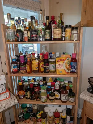 Sale Photo Thumbnail #32: Various cooking oils, vinegars, hot sauces, and condiments.