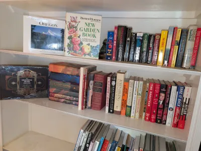 Sale Photo Thumbnail #42: hardback and paperback books, including a complete Harry Potter set and gardening guides.