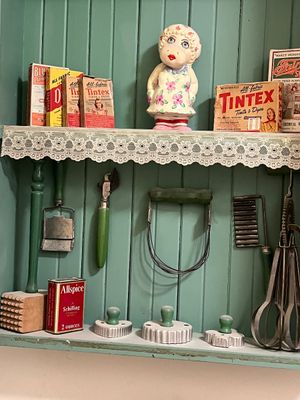 Sale Photo Thumbnail #21: Collection of vintage kitchen utensils, cookie cutters, and Tintex dye boxes displayed on a shelf with a cow figurine.