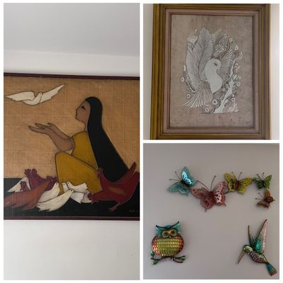 Sale Photo Thumbnail #6: Collection of bird- and butterfly-themed wall decor, including a framed mid-century style painting of a woman with birds, a framed pen-and-ink drawing of a bird, and colorful metal wall art depicting butterflies, an owl, and a hummingbird.