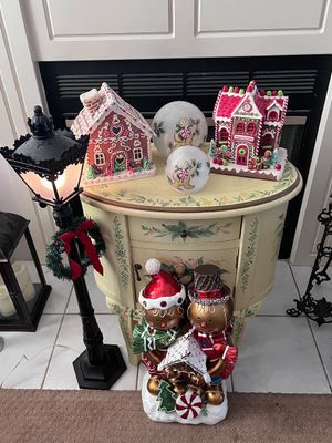 Sale Photo Thumbnail #12: Festive Christmas gingerbread-themed decor display featuring illuminated gingerbread houses, snow globes, a gingerbread couple figurine, and a mini street lamp next to a hand-painted accent table.