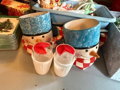 Sale Photo Thumbnail #121: Pair of ceramic snowman mugs wearing blue hats and red-and-white checkered scarves, displayed alongside vintage salt and pepper shakers.
