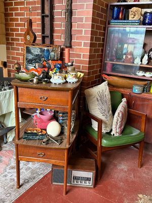 Sale Photo Thumbnail #43: Mid-century wooden two-tier telephone table with drawer, displayed alongside a mid-century green vinyl armchair and various vintage home decor items.