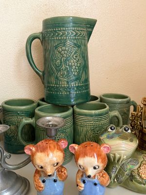 Sale Photo Thumbnail #29: Vintage green glazed ceramic pitcher and matching mug set, displayed alongside novelty bear salt and pepper shakers and a ceramic frog figurine.