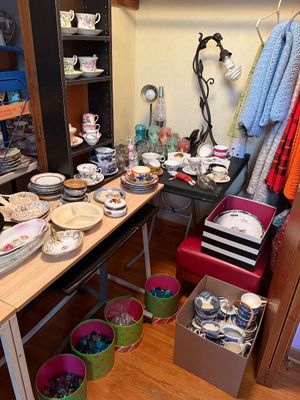 Sale Photo Thumbnail #110: Collection of vintage teacups, saucers, ceramic dishware, and glassware arranged on tables and in storage bins.