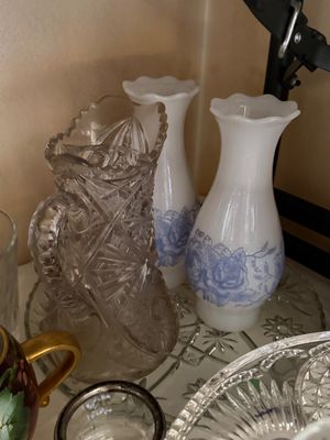 Sale Photo Thumbnail #27: Collection of vintage glassware, including a heavy cut glass pitcher and a pair of white milk glass vases with blue floral motifs.