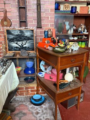 Sale Photo Thumbnail #63: Collection of mid-century home decor items including a pair of matching wooden side tables with drawers, a monochrome black velvet painting of a bonsai tree, colorful glassware, ceramics, and miscellaneous collectibles.
