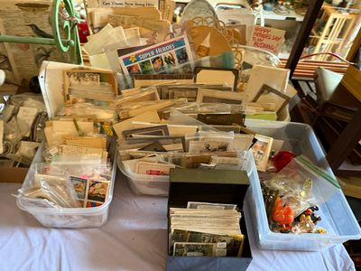 Sale Photo Thumbnail #72: Large collection of vintage ephemera, including postcards, old photographs, greeting cards, and paper collectibles, organized in plastic bins and a metal card box.