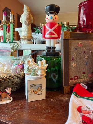 Sale Photo Thumbnail #133: Collection of vintage Christmas decor, including a plastic toy soldier blow-mold style figure, a miniature ceramic angel musical figurine, and framed needlework art.