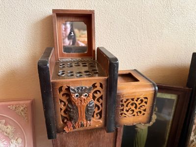 Sale Photo Thumbnail #16: Vintage carved wooden owl lipstick and vanity stand with a small flip-up mirror and filigree scrollwork details.