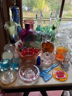 Sale Photo Thumbnail #39: Collection of vintage art glass items, including colorful vases, paperweights, a glass hatchet, carnival glass dish, and decorative bottles.