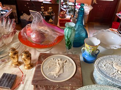Sale Photo Thumbnail #51: Collection of vintage glass, porcelain, and stone decor items including a marble trinket box with a bas-relief medallion, gold-plated salt and pepper shakers, and colorful glassware.