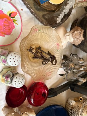 Sale Photo Thumbnail #23: Collection of vintage table top decor including a frosted glass dish containing skeleton keys, hand-painted porcelain salt and pepper shakers, and ruby red glass vessels.