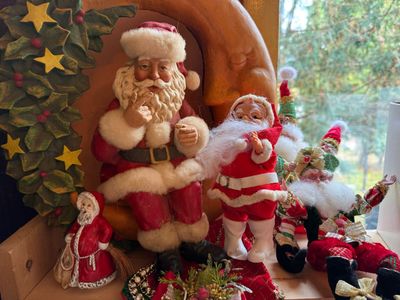 Sale Photo Thumbnail #140: Collection of vintage Santa Claus and elf figurines displayed with a crescent moon backdrop.