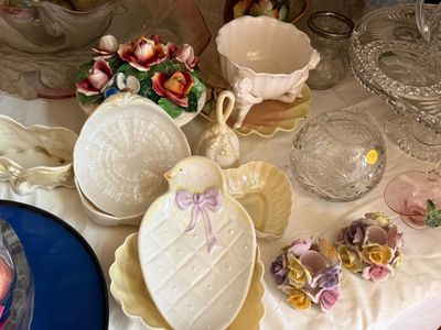 Sale Photo Thumbnail #25: Collection of vintage decorative tableware including a floral porcelain centerpiece, a bird-shaped trinket dish, cherub motif bowls, and cut glass pieces.