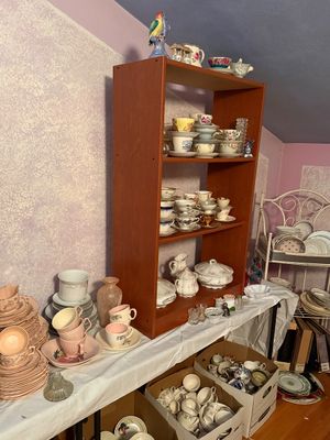 Sale Photo Thumbnail #101: Collection of vintage porcelain and china teacups, saucers, dinnerware, and decorative ceramics displayed on shelves, folding tables, and in storage boxes.