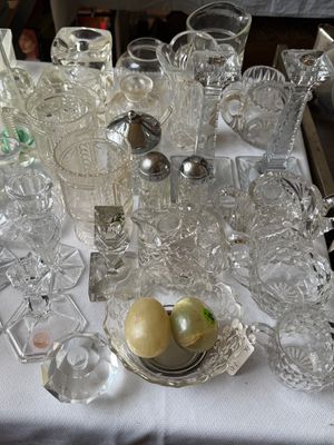 Sale Photo Thumbnail #41: Collection of pressed and cut glass tableware, including candlestick holders, pitchers, creamers, sugar bowls, and decorative stone eggs.