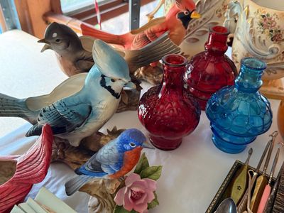 Sale Photo Thumbnail #61: Collection of decorative porcelain bird figurines and planters alongside colorful small textured glass vases.