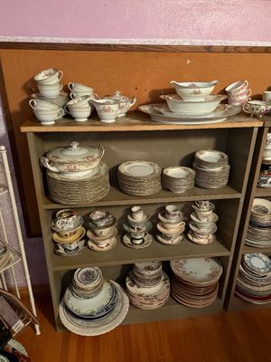 Sale Photo Thumbnail #104: Large collection of vintage floral porcelain dinnerware and teacups, neatly arranged on wooden shelving.