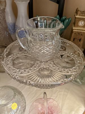 Sale Photo Thumbnail #30: Vintage pressed crystal pitcher resting on a matching round glass cake stand or server featuring embossed bird motifs.