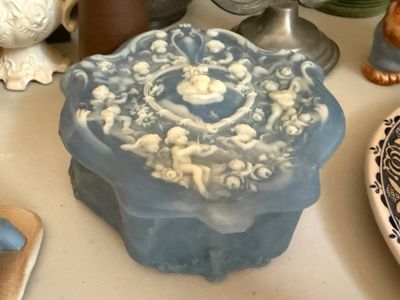 Sale Photo Thumbnail #26: Vintage light blue and white molded glass or resin trinket box featuring intricate cherub figures in high relief.